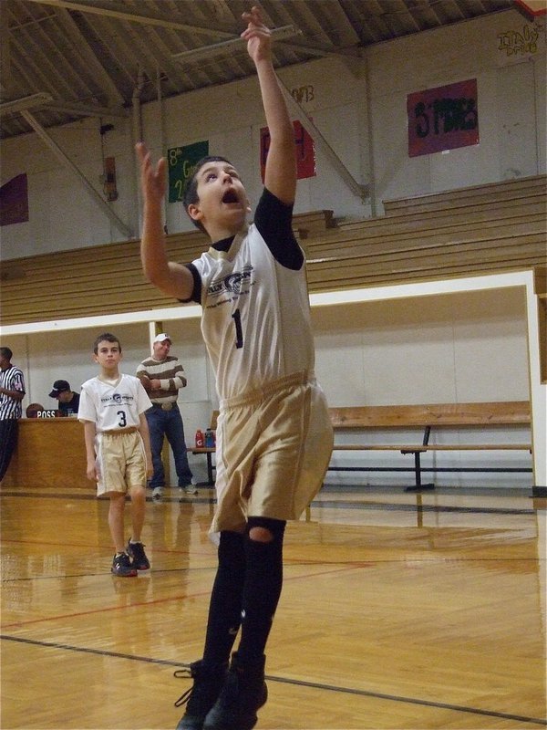 Image: Determination — Gary Escamilla(1) practices a left handed layup before the game.
