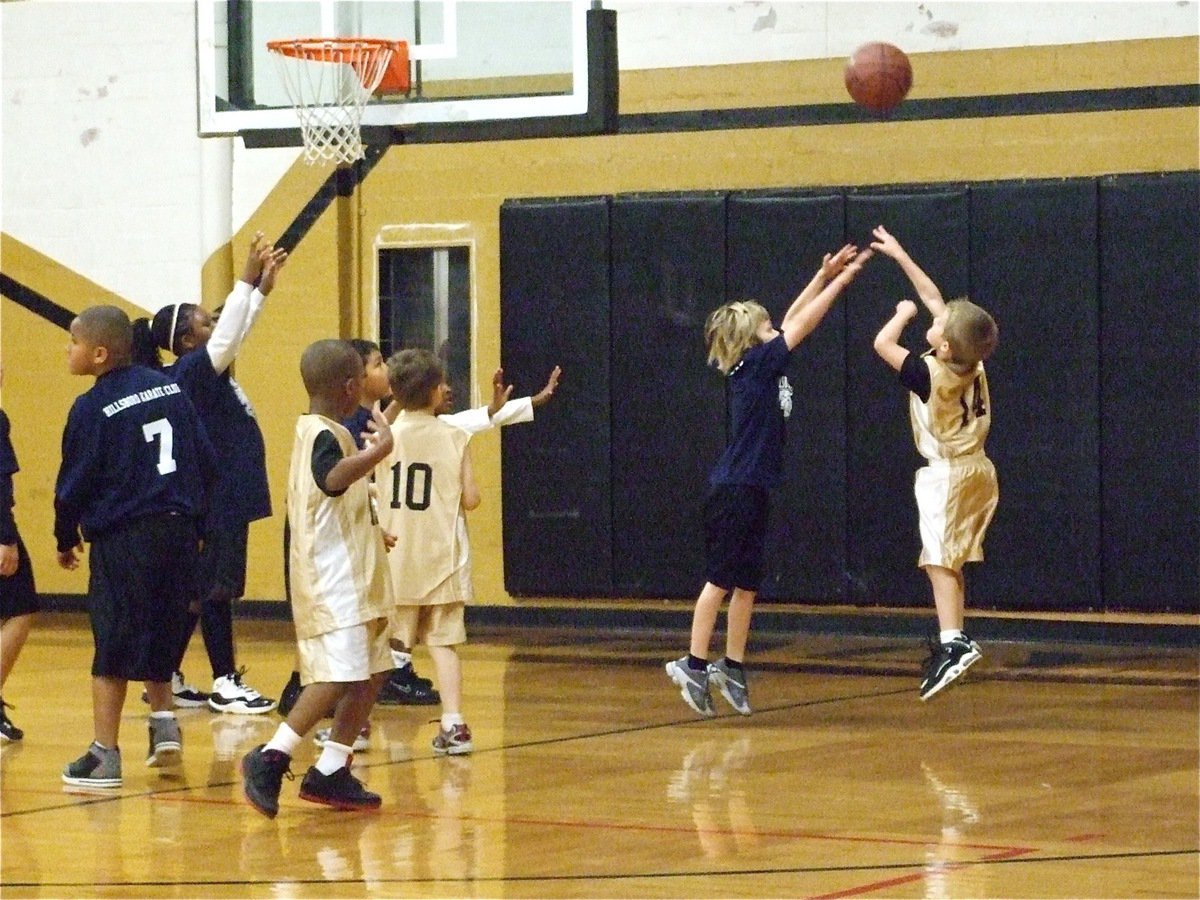 Image: A Janek jumper — Reese Janek(14) shoots a baseline jumper against Hillsboro Navy Blue as Zorian Burley(12) and Xander Galvan(10) try to get open.