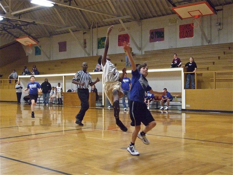 Image: Scoring with style — Michael Wilson(3) tries to complete the fast break.