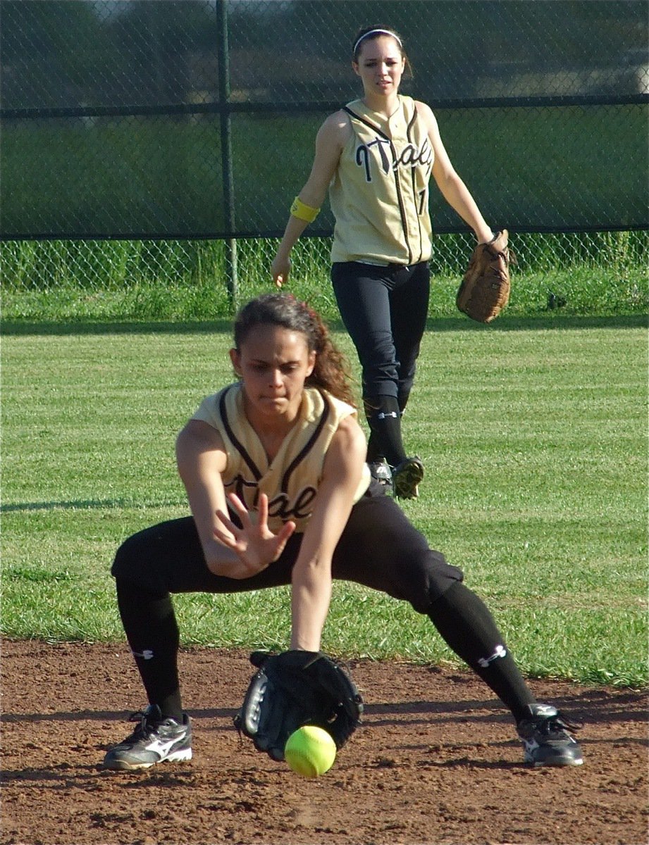 Image: Anna and Drew — Anna Viers(43) and Drew Windham(14) practice fielding grounders during the pre-game warmup.