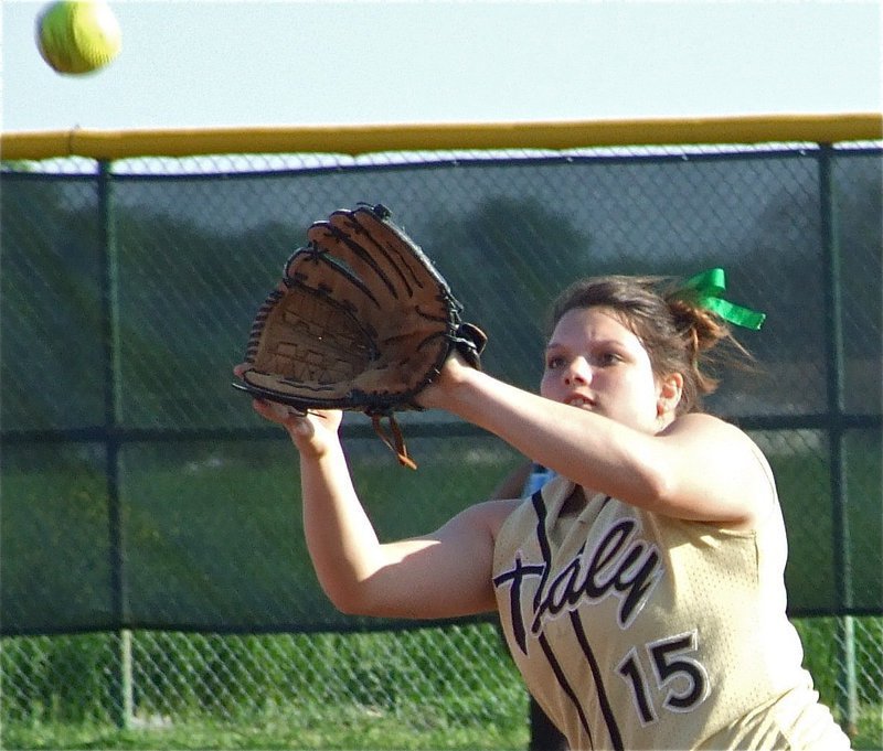 Image: Cori catches — Second baseman Cori Jeffords(15) practices catching a pop-up before the game.