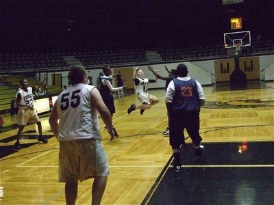 Image: J.T. shoots a jumper — J.T. Escamilla(12) launches a 3-pointer against Hampton Prep.