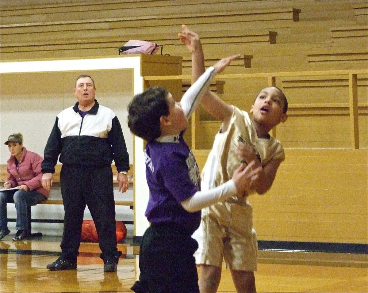 Image: Jones shoots the “J” — Cornelius Jones(3) shoots over the top of the Hillsboro Purple defense.