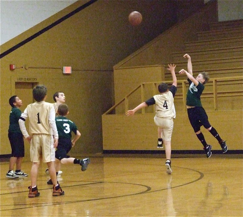 Image: Thomas defends — Italy 30’s Thomas Crowell(4) gets a hand in the face of a Hillsboro Green shooter.