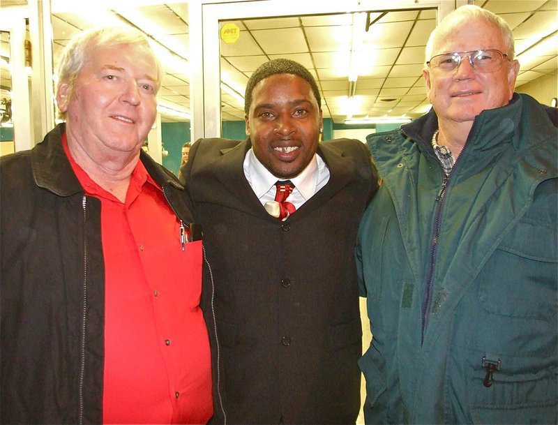 Image: Three wise men — Greg Richards, Charles Davis and Brian Eagle share an embrace in front of the Cornerstone. Greg and Brian both coached Charles in Italy sports, just a few years back.
