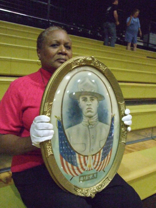 Image: John Henry Greer — Elmerine Allen Bell held the portrait of her Great Uncle John.  He registered for World War I in our hometown around 1917.  He traveled to France as a foot soldier and still has a copy of his registration papers.