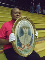Image: John Henry Greer — Elmerine Allen Bell held the portrait of her Great Uncle John.  He registered for World War I in our hometown around 1917.  He traveled to France as a foot soldier and still has a copy of his registration papers.