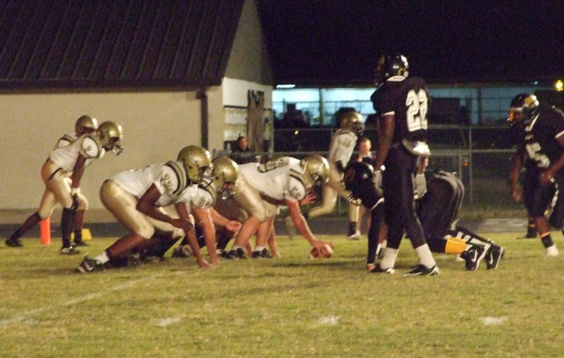 Image: The front lines — Etan Simon(50) prepares to snap while guard ivan Roldan(60) and Tackle Larry Mayberry(77) get ready to fire off and block.