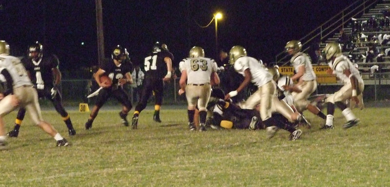 Image: Here, kitty, kitty… — Jonathan Nash(65), Zach Hernandez(63), Heath Clemons(2), Kyle Wilkins(7) and Jasenio Anderosn(11) converge on the Cats.