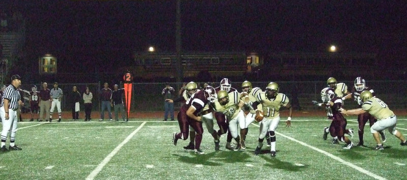 Image: On the move — #11 Jasenio Anderson breaks out of the pack of Lions as he looks for an open receiver.