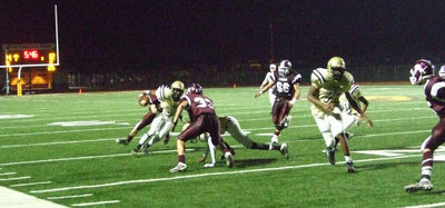 Image: Follow me… — #8 Desmond Anderson tries to pick his way down the sideline behind big #77 Larry Mayberry.