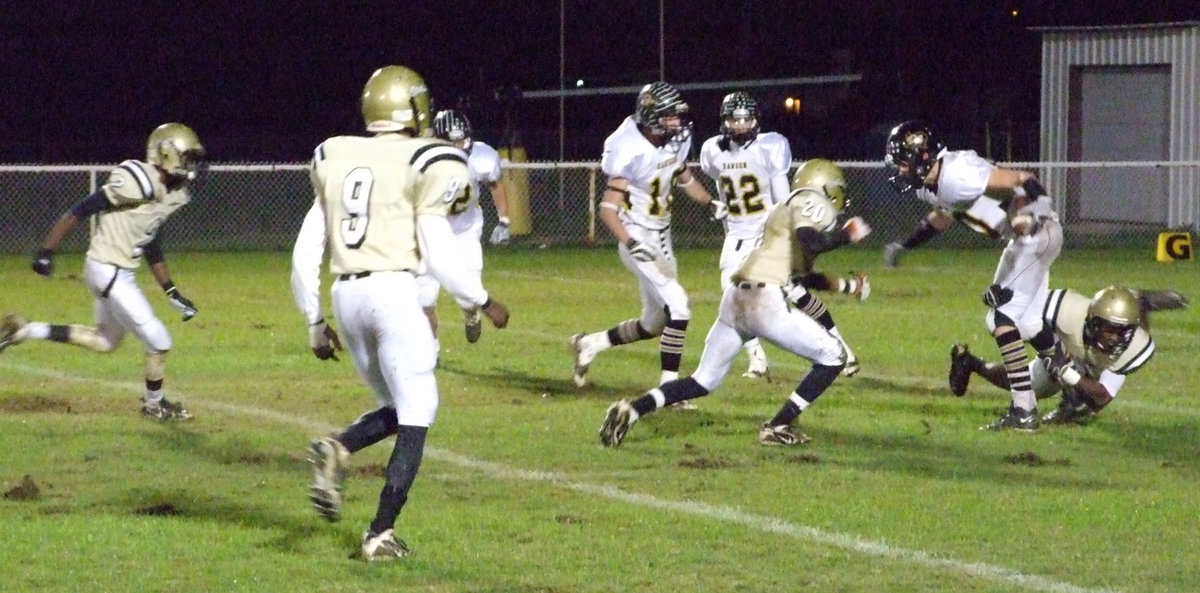 Image: Kick and catch — Desmond Anderson grabs a back leg of the Bulldog returner while Deandre Sephus(20), Aaron Thomas(9) and Heath Clemons(2) help bring him down.