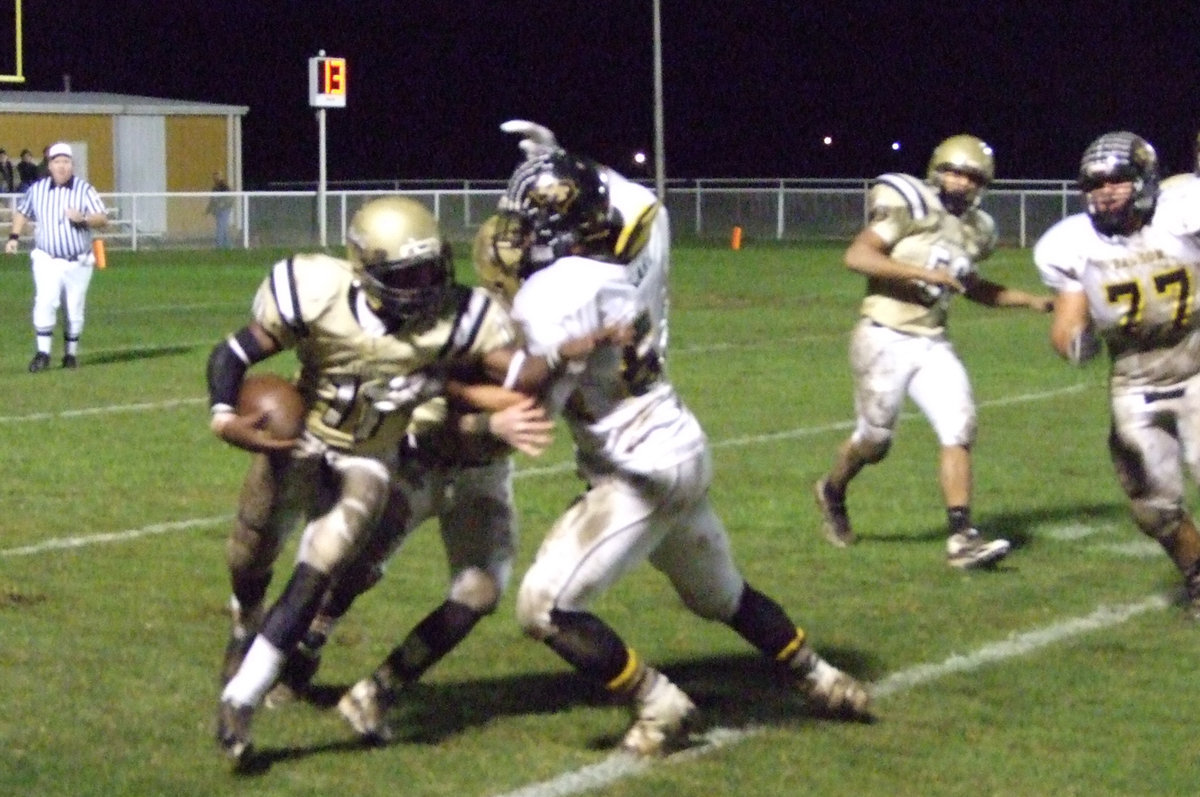 Image: Tough yards — Jasenio Anderson(11) tries to get around the edge of the Dawson defenders while Justin Hayes throws a block.