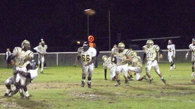 Image: Anderson makes a play — Italy quarterback Jasenio Anderson(11) got the pass away before being sacked.