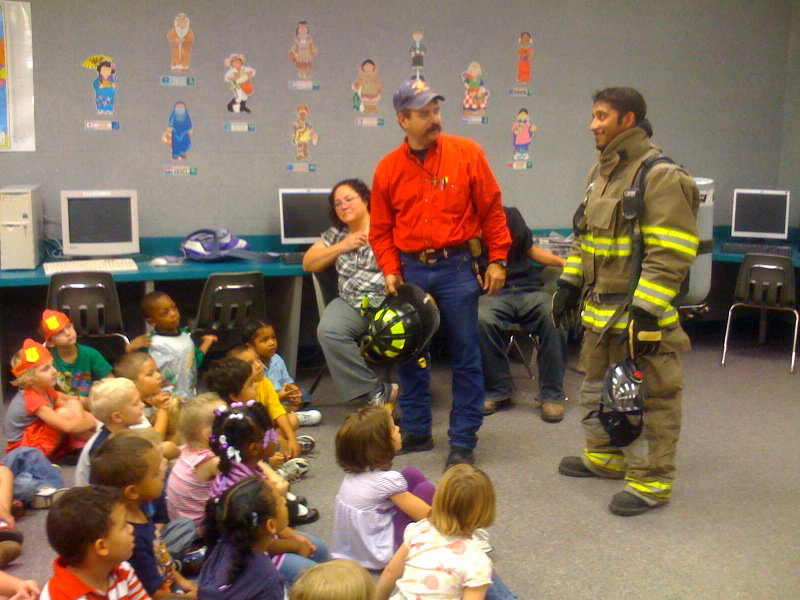 Image: See it’s really me — Jackson’s assistant is taking off the safety wear to show the children not to be scared, it is just a person under all of that gear.