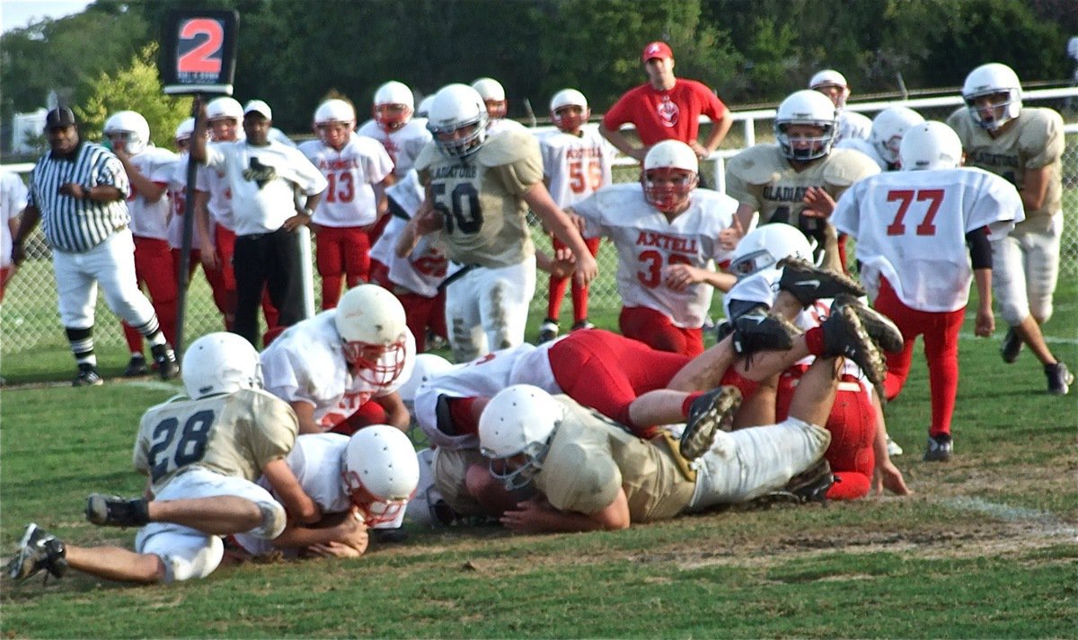 Image: Fumble rumble — The Gladiators and the Longhorns got down and dirty on Thursday.