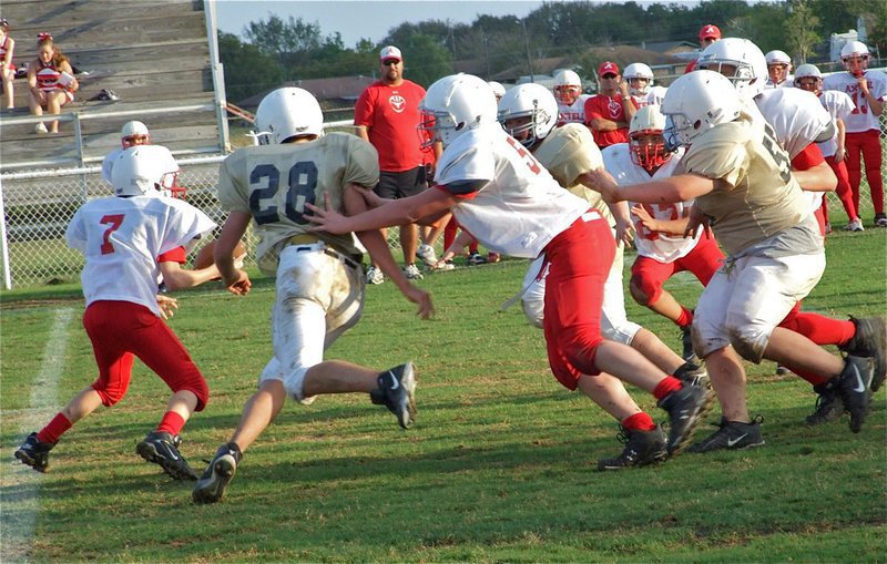 Image: What a nightmare! — Cody Medrano(28) is a nightmare for opposing offenses as he kept the Longhorn quarterback on the run with help from Kelton Bales(55) and Zain Byers.