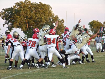 Image: Going for the block — Italy’s defense tries to block the Maypearl point after kick.