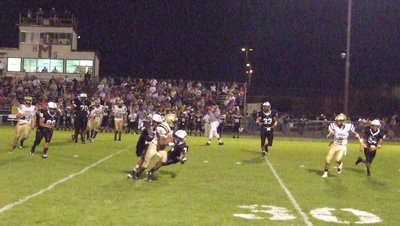 Image: Desmond runs — Desmond Anderson(8) hauls in a pass for big yards against Malakoff.