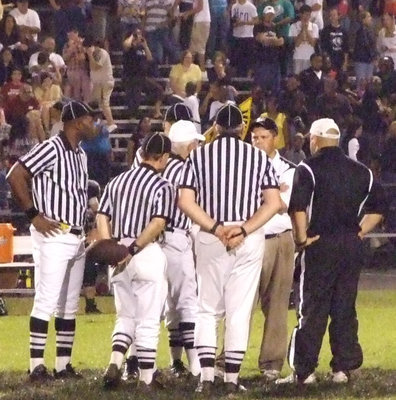 Image: Italy forces O.T. — The referees convene with both head coaches to make certain there is no confusion regarding the overtime format.