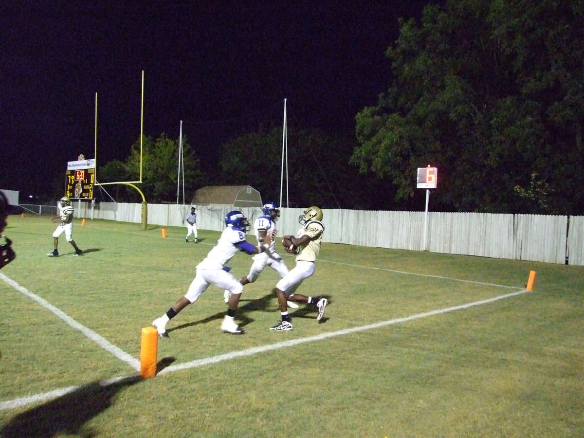 Image: Its a touchdown — Rising star, Aaron Thomas(9), out leaps two Pirates for his first touchdown catch of the 2009 season.