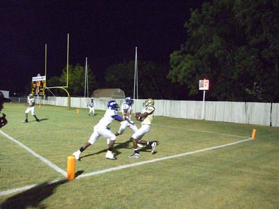 Image: Its a touchdown — Rising star, Aaron Thomas(9), out leaps two Pirates for his first touchdown catch of the 2009 season.