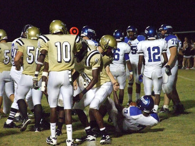 Image: Still friends — Gladiators working hard to beat the Pirates but still take a minute for good sportsmanship.