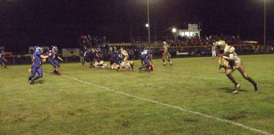 Image: Touchdown tactics — Italy receiver John Isaac tries to flank the Bulldog defenses.