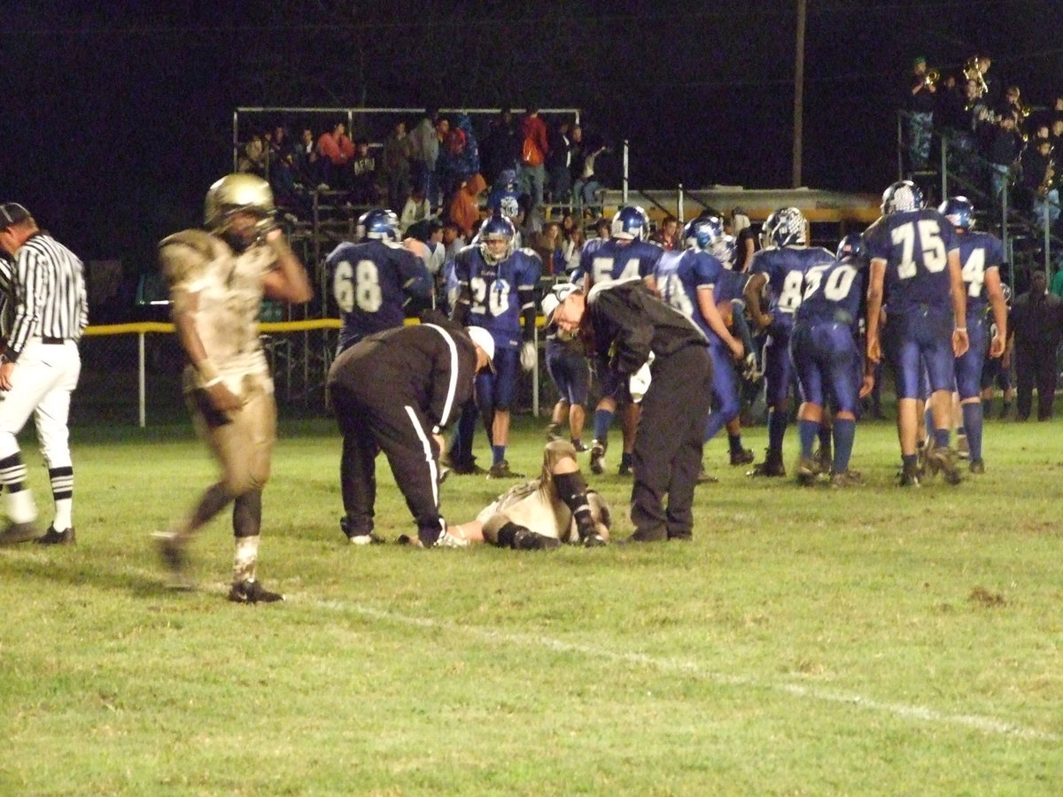 Image: Get up Ivan! — Ivan Roldan(60) gets injured on a Wortham scoring play.