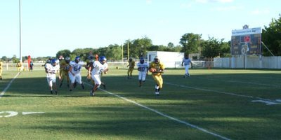 Image: Gladiator run play — Corrin Frazier runs past the line of scrimmage, deep in Gladiator territory.