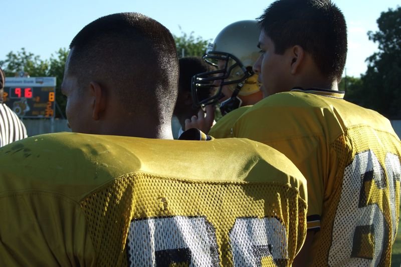 Image: Watching the battle — Jacob Lopez, Omar Estrada and Jase Holden looking on from the sidelines.