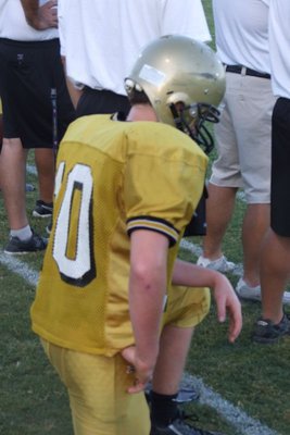 Image: Buchanan reflecting — Even on the sidelines, Justin Buchanan’s mind seems to still be on the field.