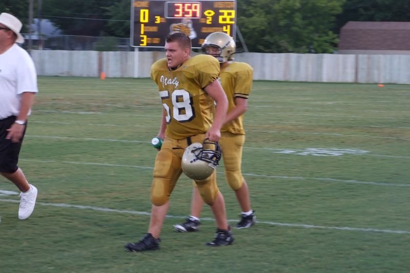 Image: Back to battle — Robert Sparks goes to the huddle.