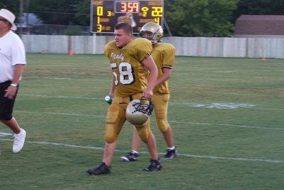 Image: Back to battle — Robert Sparks goes to the huddle.