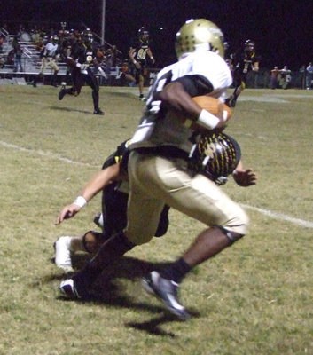 Image: Desmond Anderson — Dawson Bulldog tries to stop Anderson.