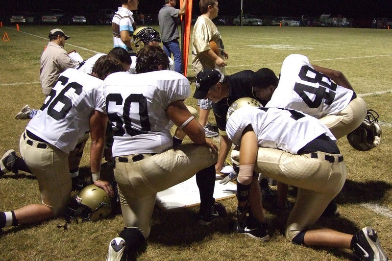 Image: Coach Coleman — Coach talks to the Gladiators about the plays.