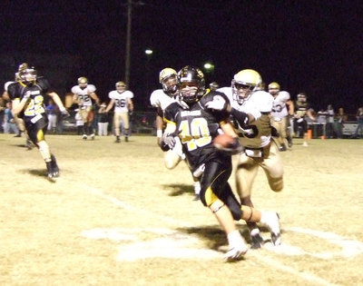 Image: Diamond Rodgers — #25 Diamond Rodgers tries to bring Dawson’s #40 Nick Renfro down.
