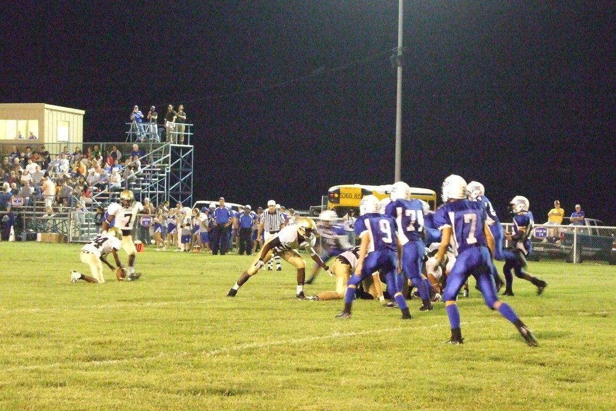 Image: Kicking a field goal — #7-Jasenio Anderson finishes the extra point.