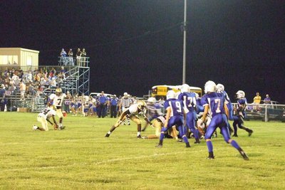 Image: Kicking a field goal — #7-Jasenio Anderson finishes the extra point.