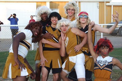 Image: Powder Puff Cheerleaders — The beautiful (ah hem) cheerleaders get ready for the night’s festivities.