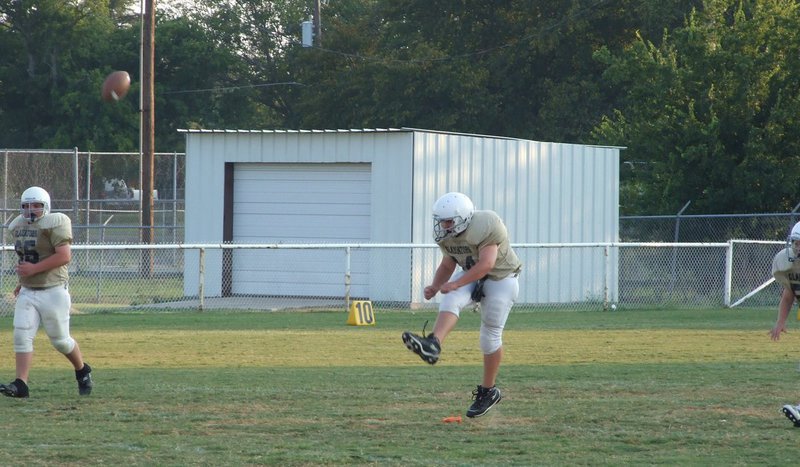 Image: Foot … ball — Kevin Roldan kicks off.