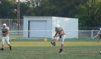 Image: Foot … ball — Kevin Roldan kicks off.