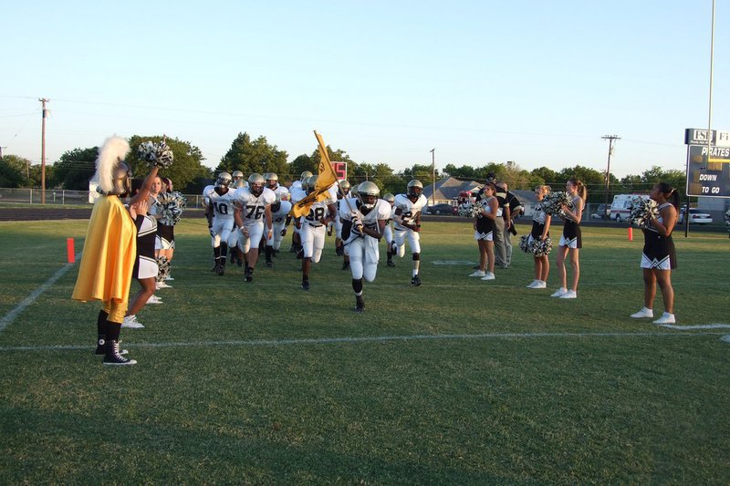 Image: Gladiators come to battle — The cheerleaders and flag core line the field as the Gladiators run to their battle stations.