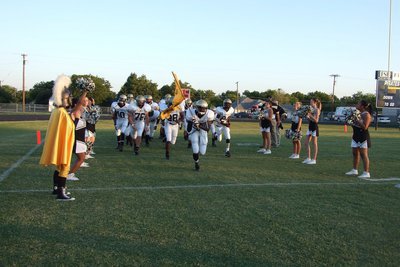 Image: Gladiators come to battle — The cheerleaders and flag core line the field as the Gladiators run to their battle stations.