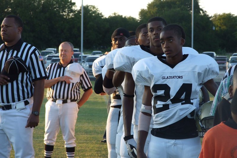 Image: Respect for our flag — The players and referees take a few minutes and honor the flag.