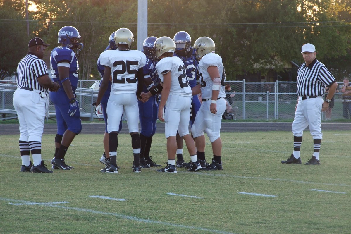 Image: Captains meet at midfield — Number 25 Diamond Rogers, Number 20 Clay Major and Number 63 Zach Hernandez are captains this week for the Gladiators.