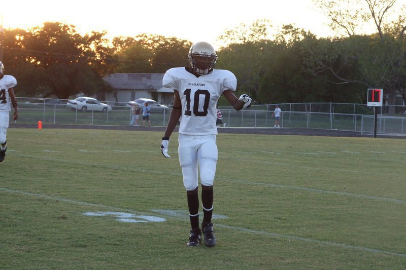 Image: Checking his spot — Number 10 John Isaac checks the ref.