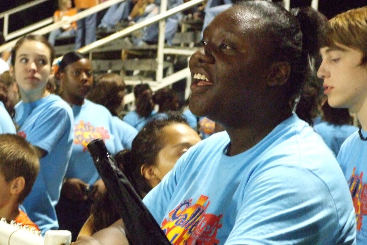Image: Nearly go time — Band members wait at the fence for their halftime performance.
