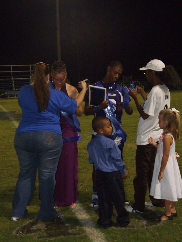 Image: Football Sweetheart and Beau — Milford ISD’s Football Sweetheart Genora Armstrong and Football Beau Derek Williamson with their family enjoying the lime light.