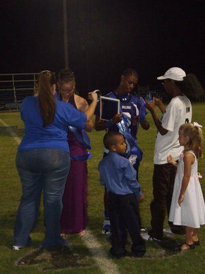 Image: Football Sweetheart and Beau — Milford ISD’s Football Sweetheart Genora Armstrong and Football Beau Derek Williamson with their family enjoying the lime light.